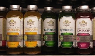 Photo of bottles of kombucha tea on a store shelf. This probiotic beverage is gluten free.