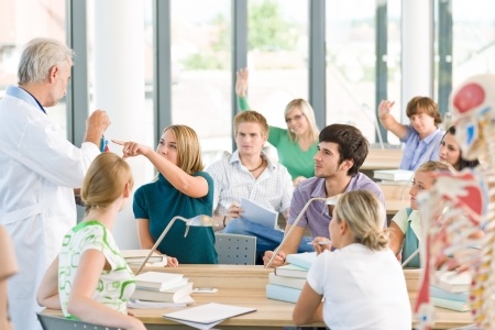 A group of medical students in a classroom with professor